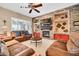 Inviting living room featuring a stone fireplace, built-in shelves, and plush leather furniture at 2959 W Eastman Dr, Anthem, AZ 85086