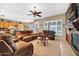 Comfortable living room featuring a fireplace, plantation shutters and plush leather seating at 2959 W Eastman Dr, Anthem, AZ 85086