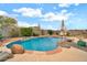 Backyard pool with rock waterfalls, desert landscaping, and plenty of space for entertaining at 2959 W Eastman Dr, Anthem, AZ 85086