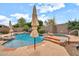 Beautiful backyard pool and spa area surrounded by lush landscaping, stone accents, and a serene waterfall feature at 2959 W Eastman Dr, Anthem, AZ 85086