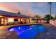 Inviting backyard oasis featuring a sparkling pool, lush landscaping, and covered patio area for relaxing at 3037 E Mallory St, Mesa, AZ 85213