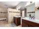 Bathroom with double sink vanity, decorative tile accents, and access to the shower and toilet at 3037 E Mallory St, Mesa, AZ 85213