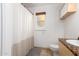 Bright bathroom features a window, vanity, and neutral-colored shower curtain at 3037 E Mallory St, Mesa, AZ 85213