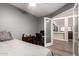 Bedroom with gray walls, desk and view to living room at 3037 E Mallory St, Mesa, AZ 85213