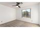 Bedroom featuring a ceiling fan and bright window with neighborhood views and natural light at 3037 E Mallory St, Mesa, AZ 85213