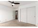 Bright bedroom featuring a large closet with mirrored sliding doors and a ceiling fan at 3037 E Mallory St, Mesa, AZ 85213