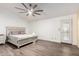 Bright bedroom features neutral walls, laminate flooring, and a stylish ceiling fan at 3037 E Mallory St, Mesa, AZ 85213