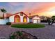 Charming single-story home featuring a well-maintained lawn, desert landscaping, and a spacious three-car garage at 3037 E Mallory St, Mesa, AZ 85213