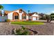 Charming single-Gathering home boasting a manicured lawn, desert landscaping, and a three-car garage at 3037 E Mallory St, Mesa, AZ 85213