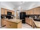 Well-equipped kitchen with granite countertops, stainless steel appliances, and center island at 3037 E Mallory St, Mesa, AZ 85213