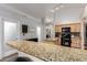 Open-concept kitchen features granite countertops, an island, and a breakfast bar for casual dining at 3037 E Mallory St, Mesa, AZ 85213