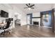 Inviting living room features luxury vinyl flooring, a fireplace, modern lighting and neutral wall colors at 3037 E Mallory St, Mesa, AZ 85213