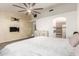 Comfortable bedroom featuring a wall-mounted fireplace, luxury vinyl flooring, and ensuite bathroom access at 3037 E Mallory St, Mesa, AZ 85213