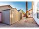 The backyard boasts two storage sheds complemented by a paved area and mature palm trees at 3037 E Mallory St, Mesa, AZ 85213