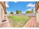 Expansive backyard with green grass, brick patio and block wall fence at 3124 W Port Royale Ln, Phoenix, AZ 85053