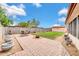 Private backyard includes a brick patio area, lush lawn, potted plants, and a storage shed at 3124 W Port Royale Ln, Phoenix, AZ 85053