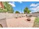 Relaxing backyard features a brick patio, seating area, decorative planters, and privacy walls at 3124 W Port Royale Ln, Phoenix, AZ 85053