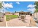 Backyard with a brick patio, outdoor seating, planters, shed, and a well-manicured lawn at 3124 W Port Royale Ln, Phoenix, AZ 85053