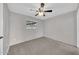 Bedroom featuring neutral carpet, ceiling fan, and natural light from window at 3124 W Port Royale Ln, Phoenix, AZ 85053