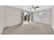 Bright bedroom features plush carpeting, ceiling fan, and sliding doors to backyard at 3124 W Port Royale Ln, Phoenix, AZ 85053