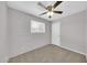 Cozy bedroom with neutral carpet, ceiling fan, and window for natural light at 3124 W Port Royale Ln, Phoenix, AZ 85053