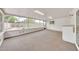 Open bonus room with carpet, brick walls, and floor-to-ceiling windows overlooking the yard at 3124 W Port Royale Ln, Phoenix, AZ 85053