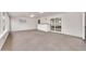 Large, carpeted bonus room featuring white brick walls and multiple windows at 3124 W Port Royale Ln, Phoenix, AZ 85053