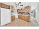 Eat-in kitchen with tile floors, wooden cabinets, and white appliances at 3124 W Port Royale Ln, Phoenix, AZ 85053