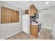 Functional kitchen with oak cabinets, white appliances, and mosaic tile backsplash at 3124 W Port Royale Ln, Phoenix, AZ 85053