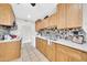Well-lit kitchen with wooden cabinets, tile backsplash, and modern countertops at 3124 W Port Royale Ln, Phoenix, AZ 85053