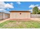 Detached outbuilding with a flower detail, set against green grass and a blue sky at 3124 W Port Royale Ln, Phoenix, AZ 85053