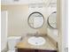 Bathroom featuring a vanity, round mirror, and neutral walls at 3500 N Hayden Rd # 206, Scottsdale, AZ 85251