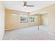 Bedroom featuring a mirrored closet, neutral walls, carpet, and window at 3500 N Hayden Rd # 206, Scottsdale, AZ 85251