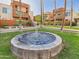 Beautiful community courtyard featuring lush green grass, mature trees, and a lovely water fountain at 3500 N Hayden Rd # 206, Scottsdale, AZ 85251