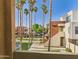 Exterior view from patio showing tall palms trees and community landscaping and buildings at 3500 N Hayden Rd # 206, Scottsdale, AZ 85251