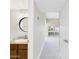 Neutral hallway leading into bathroom with vanity and a living room at 3500 N Hayden Rd # 206, Scottsdale, AZ 85251