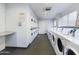 Clean and functional laundry room with multiple washers and dryers at 3500 N Hayden Rd # 206, Scottsdale, AZ 85251