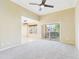 Bright living room with ceiling fan, open to dining area, and sliding door to outdoor space at 3500 N Hayden Rd # 206, Scottsdale, AZ 85251