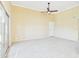 Living room with neutral walls, ceiling fan and carpet flooring with door entry and sliding glass door at 3500 N Hayden Rd # 206, Scottsdale, AZ 85251
