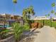 Well-maintained community pool area with lush landscaping and mature palm trees surrounding it at 3500 N Hayden Rd # 206, Scottsdale, AZ 85251