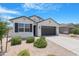 Charming single-story home with desert landscaping, black shutters, and a modern two-car garage at 35585 W San Alvarez Ave, Maricopa, AZ 85138