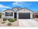 Well-maintained single-Gathering home with desert landscaping, a two-car garage and covered entryway at 35585 W San Alvarez Ave, Maricopa, AZ 85138