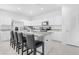 Modern kitchen with white cabinetry, stainless steel appliances, granite countertops, and counter seating at 35585 W San Alvarez Ave, Maricopa, AZ 85138