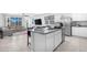 Bright, open kitchen featuring an island, stainless steel appliances, and views into the living room at 35585 W San Alvarez Ave, Maricopa, AZ 85138