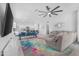 Open-concept living room with modern furniture, bright walls, and tile floors, ideal for entertaining at 35585 W San Alvarez Ave, Maricopa, AZ 85138