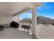 Covered patio with outdoor seating offers relaxing backyard views at 35585 W San Alvarez Ave, Maricopa, AZ 85138