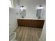 Bathroom with double vanity, modern mirrors, and white marble countertops at 3627 W Palmaire Ave, Phoenix, AZ 85051