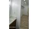 Bright bathroom featuring a modern vanity with white countertops and wood-look laminate floors at 3627 W Palmaire Ave, Phoenix, AZ 85051