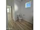 Bathroom featuring neutral walls, laminate floors, and a toilet at 3627 W Palmaire Ave, Phoenix, AZ 85051