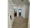 Hallway with white doors, wood-look flooring, and an entry way to a bedroom and bathroom at 3627 W Palmaire Ave, Phoenix, AZ 85051